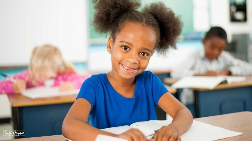 elementary student writing in a math journal