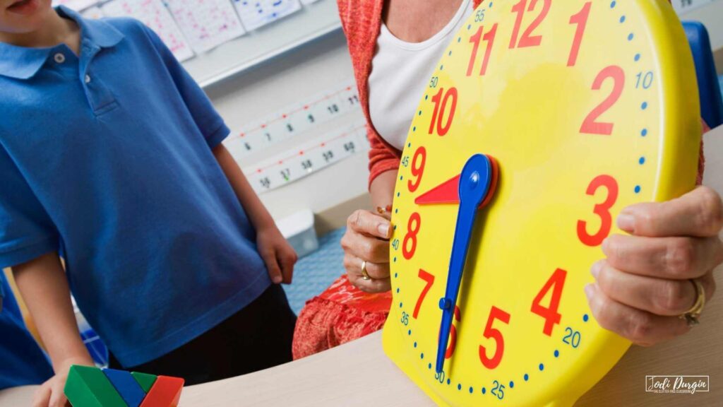 teacher showing student how to tell time