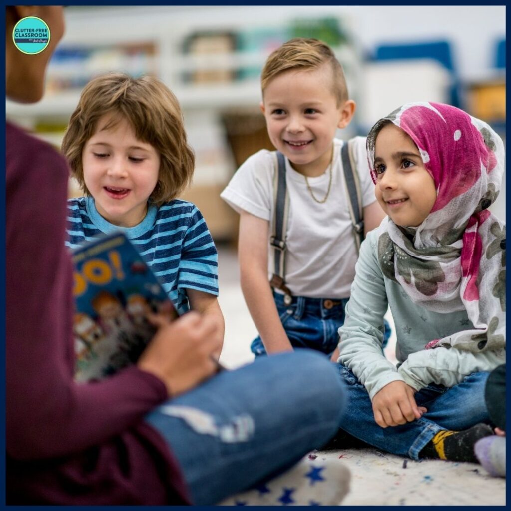 elementary students listening to a picture book being read aloud by their teacher