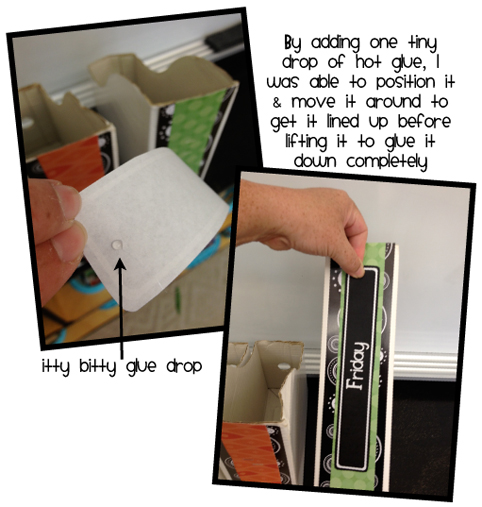 teacher putting labels on magazine holders to use as organization system for organizing worksheets