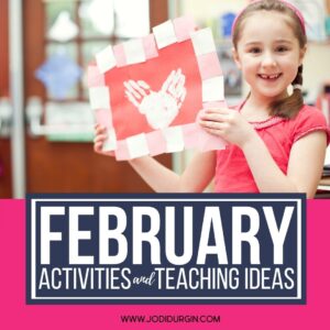 elementary-aged girl holding up a Valentine's Day craft she made