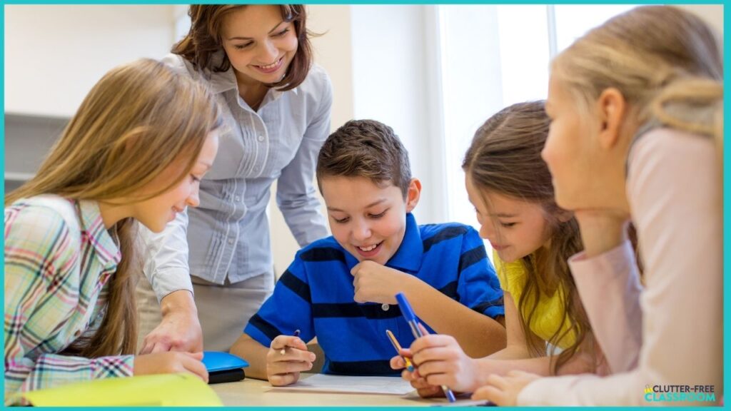 4 students working together to solve a problem with a teacher observing them